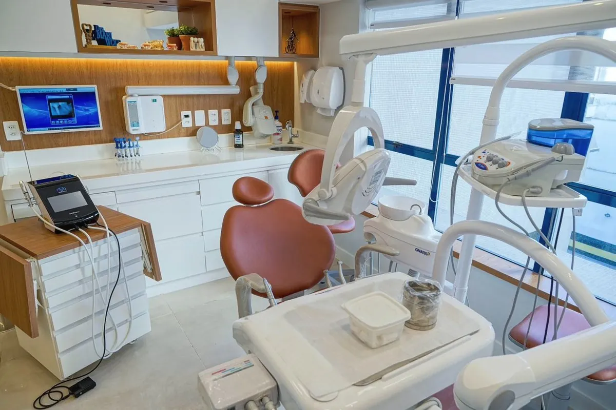 Sala clínica com a cadeira e o escâner intraoral